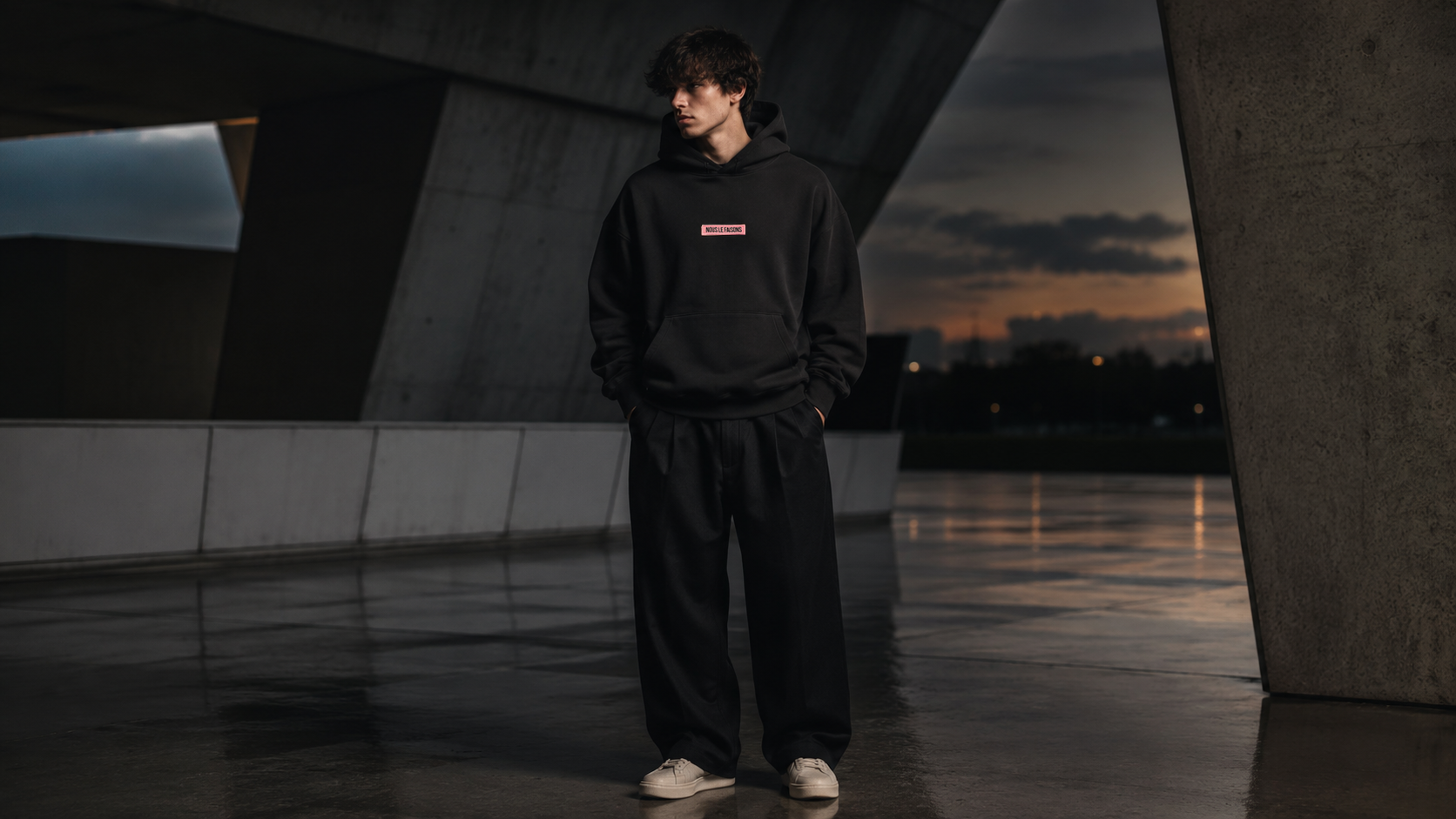 Nous Le Faisons premium clothing styled in a modern lifestyle setting