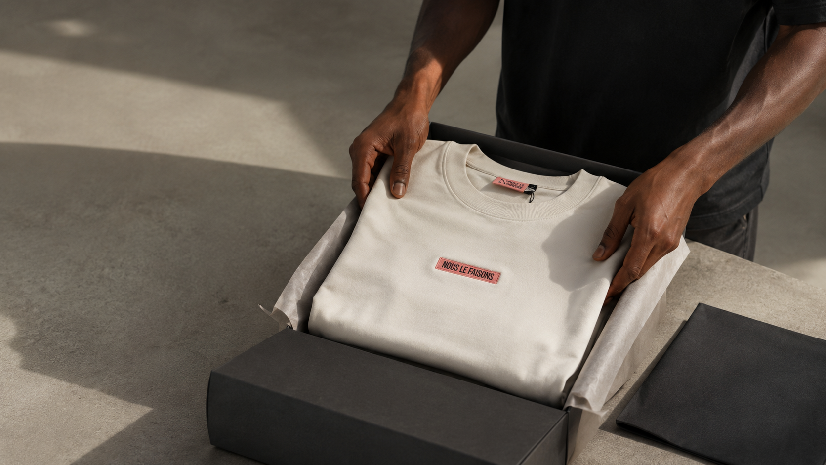 Nous le Faisons box and shirt